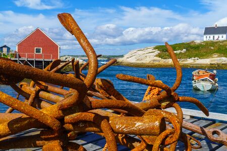 View of rusty anchors, boats and houses, in the fishing village Peggys Cove, Nova Scotia, Canadaの写真素材