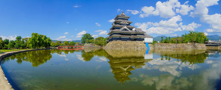Matsumoto, Japan - October 1, 2019: Panoramic view of the Matsumoto Castle (or Crow Castle) and bridge, with locals and visitors, in Matsumoto, Japanのeditorial素材