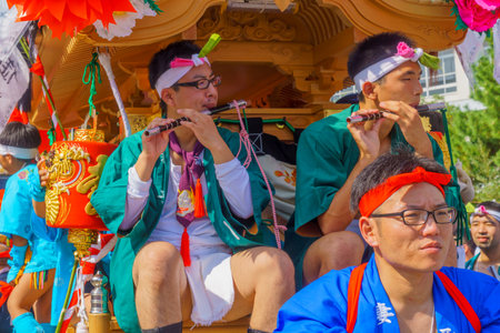 Himeji, Japan - October 14, 2019: Men in traditional dressing, flutes, and portable shrines take part in the Nada no Kenka Festival, in Himeji, Japanのeditorial素材