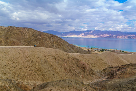 Eilat, Israel - January 18, 2020: View of the gulf of Aqaba, with hikers. Eilat Mountains, southern Israel and Jordanのeditorial素材