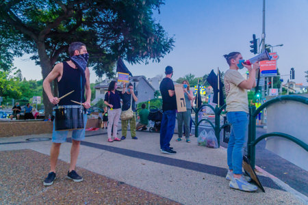 Haifa, Israel - October 06, 2020: People protest within 1km from home, against the government, Bibi Netanyahu, and the recent lock-down in Ziv center, Haifa, Israelのeditorial素材