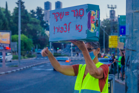 Haifa, Israel - October 06, 2020: Protestor with sign, protests within 1km from home, against the government, Bibi Netanyahu, and the recent lock-down in Ziv center, Haifa, Israelのeditorial素材