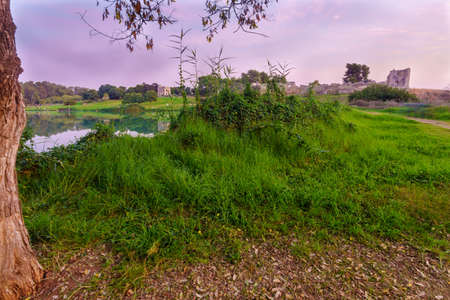 Sunset view of the lake, with the Antipatris Fort (Binar Bashi), in Yarkon (Tel Afek) National Park, central Israelの写真素材