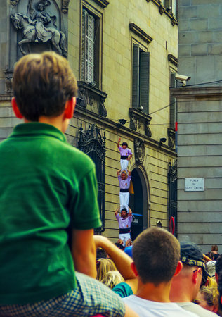 Barcelona, Spain - September 23, 1999: Crowd of people watch as locals are building human towers (Castellers), part of the traditional La Merce Festival, in Barcelona, Spainのeditorial素材