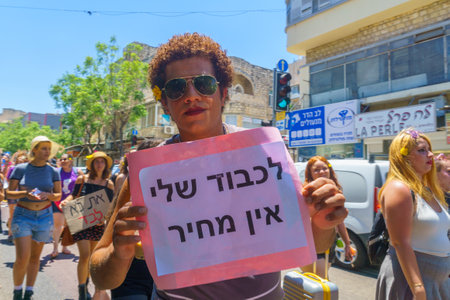 Haifa, Israel - July 09, 2021: Slut walk protest, against the rape culture: people with signs marching in the street - message - no price tag for my dignity. Haifa, Israelのeditorial素材