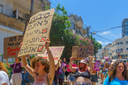 Haifa, Israel - July 09, 2021: Slut walk protest, against the rape culture: people with various signs marching in the street. Haifa, Israelのeditorial素材