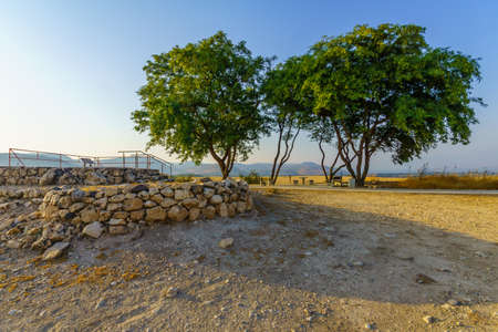 View of ancient Israelite buildings remains, with trees and landscape, in Tel Hazor National Park