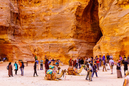 Petra, Jordan - October 23, 2021: Tourism scene with locals, visitors, and camels, in the ancient Nabatean city of Petra, Southern Jordanのeditorial素材