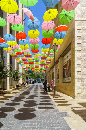 Jerusalem, Israel - August 30, 2021: Pedestrians and colorful umbrellas (parasols), in Yoel Moshe Solomon Street, the historic Nachalat Shiva neighborhood, the picturesque center of Jerusalem, Israelのeditorial素材