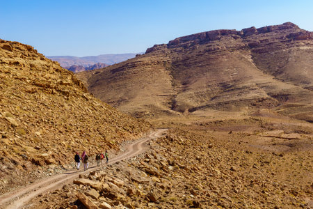 Petra, Jordan - October 24, 2021: View of desert mountain landscape, with locals and a donkey, near Petra, in Southern Jordanのeditorial素材