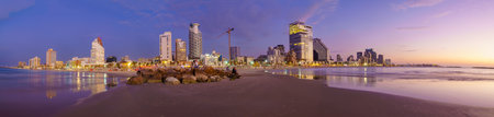 Tel-Aviv, Israel - November 22, 2021: Blue hour (after sunset) panorama of the beach scene of Tel-Aviv and old Jaffa, with visitors. Now Tel-Aviv-Yafo, Israelのeditorial素材