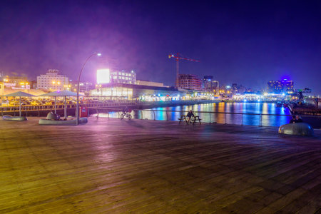Tel-Aviv, Israel - November 24, 2021: Evening scene of the historic port compound, with old crane and local businesses. Tel-Aviv, Israelのeditorial素材