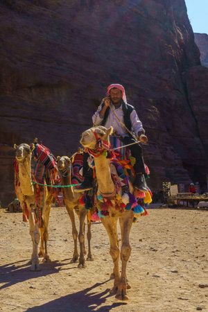 Petra, Jordan - October 23, 2021: View of a Bedouin man with camels, in the ancient Nabatean city of Petra, Southern Jordanのeditorial素材