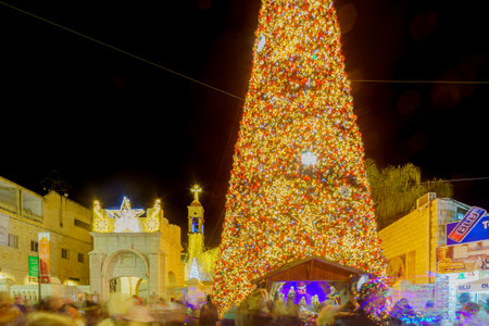 Nazareth, Israel - December 24, 2021: Evening view of the church square (near Mary well), with the Greek Orthodox Church of the Annunciation, Christmas tree, and nativity scene, in Nazareth, Israelのeditorial素材