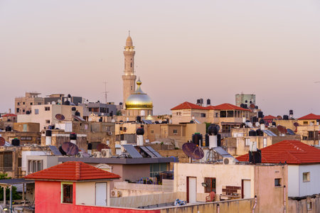 Tayibe, Israel - April 09, 2022: Sunset rooftop view of the ancient center and Salah al-Din Mosque, in Tayibe, a Muslim Arab town in central Israelのeditorial素材
