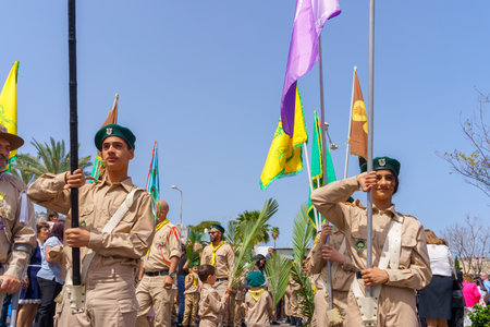 Haifa, Israel - April 10, 2022: Scout flag carriers and others take part in the Easter Palm Sunday parade of the Greek Catholic Melkite community, in Downtown Haifa, Israelのeditorial素材