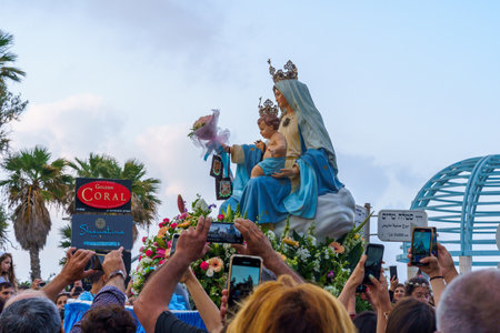 Haifa, Israel - May 01, 2022: Mary statue is photographed by believers, in Our Lady of Mount Carmel parade, near Stella Maris, in Haifa, Israel. This annual event commemorates its hiding in WWIのeditorial素材