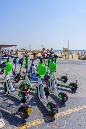 Tel-Aviv, Israel - May 26, 2022: Scene of the beach, with electric scooter for rent, locals and visitors, in Tel-Aviv, Israelのeditorial素材