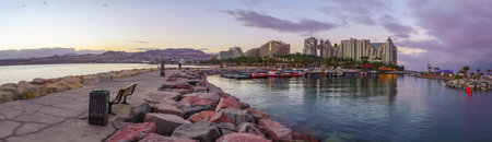 Eilat, Israel - January 15, 2022: Winter sunset panorama of the marina pier, with visitors and hotel buildings. Eilat, southern Israelのeditorial素材