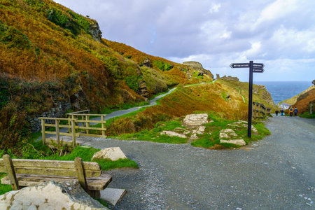 Tintagel, UK - October 15, 2022: View of footpath, directional signs, and visitors, in Tintagel, Cornwall, England, UKのeditorial素材
