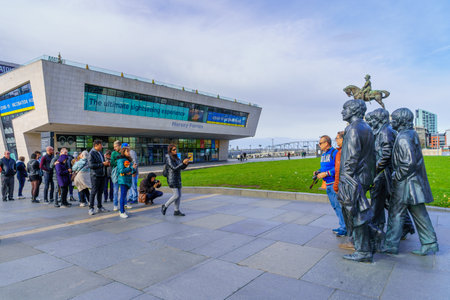 Liverpool, UK - October 09, 2022: Pier scene, with people queuing to a photo with the Beatles monument, in Liverpool, Merseyside, England, UKのeditorial素材