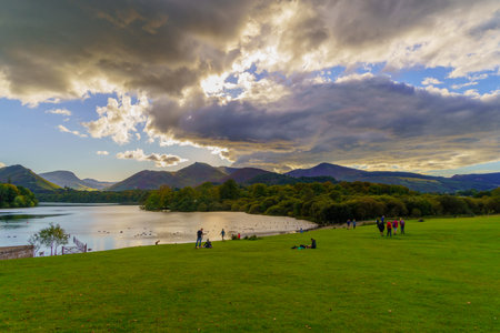 Keswick, UK - September 24, 2022: Lakeside scene of Derwentwater lake, with visitors, Keswick, the Lake District, Cumbria, England, UKのeditorial素材