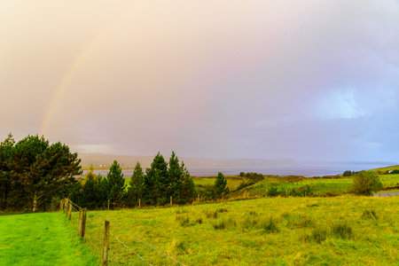 Morning view over the Loch Snizort Beag, with countryside and a rainbow, in the Isle of Skye, Inner Hebrides, Scotland, UKの写真素材