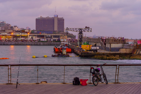 Tel-Aviv, Israel - June 17, 2022: Sunset scene of the port, with visitors, in Tel-Aviv, Israelのeditorial素材