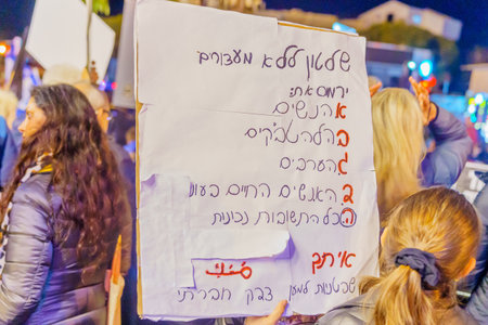 Haifa, Israel - January 14, 2023: People protest with signs against the legislative plans of the new government, in Haifa, Israelのeditorial素材