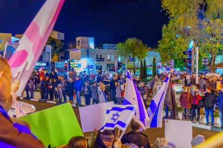 Haifa, Israel - January 14, 2023: Crowd of people protest with various signs against the legislative plans of the new government, in Haifa, Israelのeditorial素材