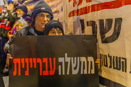 Haifa, Israel - January 14, 2023: People protest with signs against the corruption of the new government, in Haifa, Israelのeditorial素材