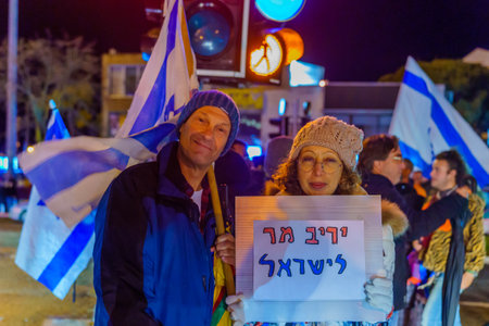 Haifa, Israel - January 14, 2023: People protest with signs against the legislative plans of the new...