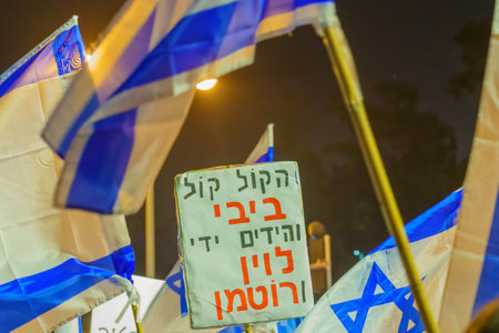 Haifa, Israel - January 28, 2023: Various signs and flags raised during a demonstration in protest...