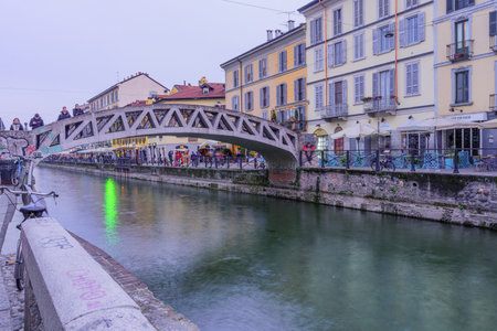 Milan, Italy - March 02, 2022: Sunset view of the Naviglio Grande canal, with locals and visitors, in Navigli, Milan, Lombardy, Northern Italyのeditorial素材