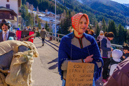 Valfloriana, Italy - February 26, 2022: Carnival participants in traditional costumes, and spectators, in the Valfloriana carnival, Trentino, Northern Italyのeditorial素材