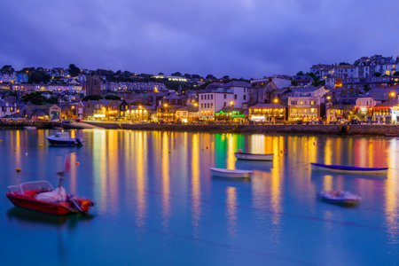 St Ives, UK - October 14, 2022: Evening view of the harbor, with various businesses, in St Ives, Cornwall, England, UKのeditorial素材