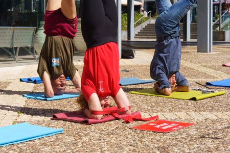 Haifa, Israel - March 16, 2023: Yoga headstand protesters, part of a protest day against the plans...