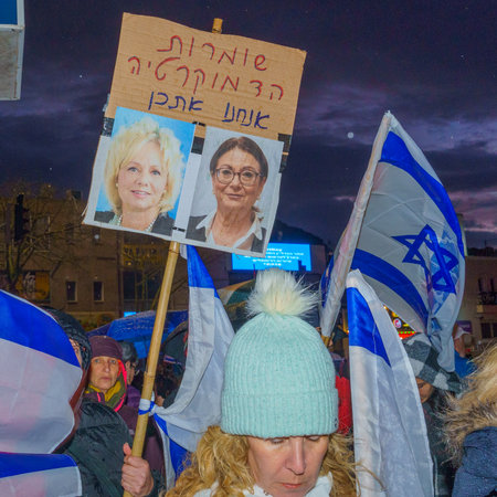 Haifa, Israel - March 18, 2023: Protesters with various signs and flags attend a demonstration against the plans of the new government, claiming its anti-democratic, in Haifa, Israelのeditorial素材