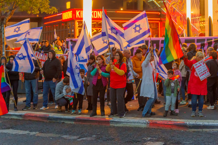 Haifa, Israel - March 18, 2023: Protesters with various signs and flags attend a demonstration against the plans of the new government, claiming its anti-democratic, in Haifa, Israelのeditorial素材