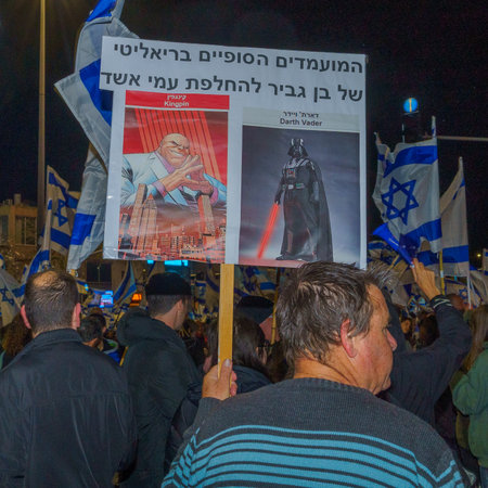 Haifa, Israel - March 18, 2023: Protesters with various signs and flags attend a demonstration against the plans of the new government, claiming its anti-democratic, in Haifa, Israelのeditorial素材
