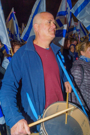 Haifa, Israel - March 18, 2023: Protesters with various musical instruments and flags attend a demonstration against the plans of the new government, claiming its anti-democratic, in Haifa, Israelのeditorial素材