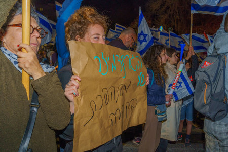 Haifa, Israel - March 18, 2023: Protesters with various signs and flags attend a demonstration against the plans of the new government, claiming its anti-democratic, in Haifa, Israelのeditorial素材