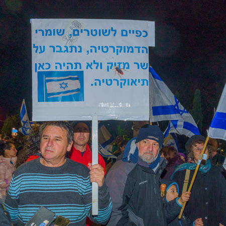 Haifa, Israel - March 18, 2023: Protesters with various signs and flags attend a demonstration against the plans of the new government, claiming its anti-democratic, in Haifa, Israelのeditorial素材