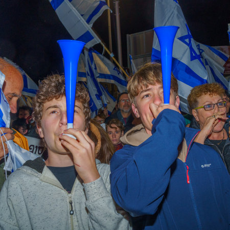 Haifa, Israel - March 18, 2023: Protesters with various musical instruments and flags attend a demonstration against the plans of the new government, claiming its anti-democratic, in Haifa, Israelのeditorial素材