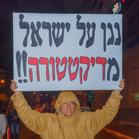 Haifa, Israel - March 18, 2023: Protesters with various signs and flags attend a demonstration against the plans of the new government, claiming its anti-democratic, in Haifa, Israelのeditorial素材