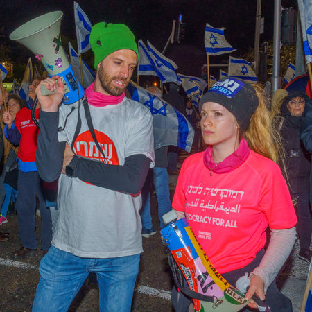 Haifa, Israel - March 18, 2023: Protesters with megaphones attend a demonstration against the plans of the new government, claiming its anti-democratic, in Haifa, Israelのeditorial素材