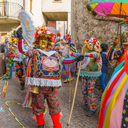 Schignano, Italy - February 18, 2023: Participants in traditional costume and mask of Mascarun (lucky, rich), part of the traditional carnival of Schignano, Lake Como, Lombardy, Northern Italyのeditorial素材