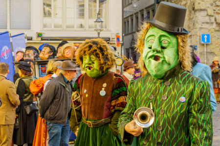 Lucerne, Switzerland - February 20, 2023: Scene of streets with participant and others, some in costumes, during the Fasnacht Carnival, in Lucerne (Luzern), Switzerlandのeditorial素材