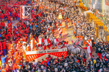 Ivrea, Italy - February 19, 2023: Battle of the Oranges scene of the town square (Piazza di Citta), with fighters and crowd, part of the historical carnival of Ivrea, Piedmont, Northern Italyのeditorial素材