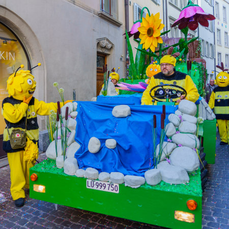 Lucerne, Switzerland - February 20, 2023: Group of participants in costumes march in the streets, and crowd, part of the Fasnacht Carnival, in Lucerne (Luzern), Switzerlandのeditorial素材